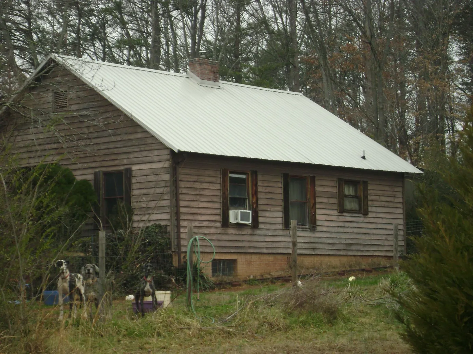 White metal roof on an old wood sided farmhouse, from a Metal Roof Installation job in Pitman